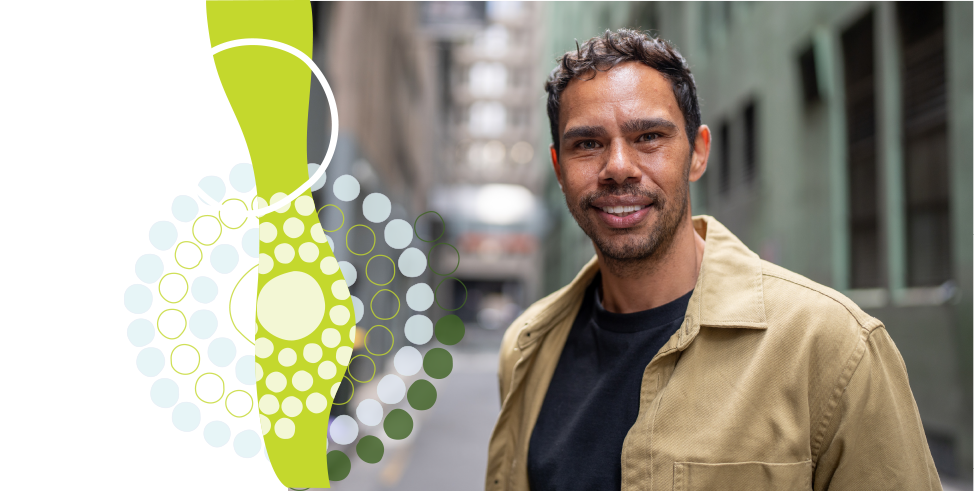 Aboriginal man smiling on a city street with Windaan graphic motif