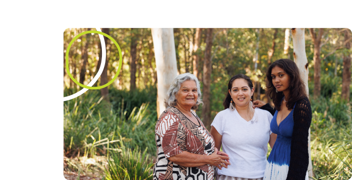Three generations of Aboriginal women together in bushland